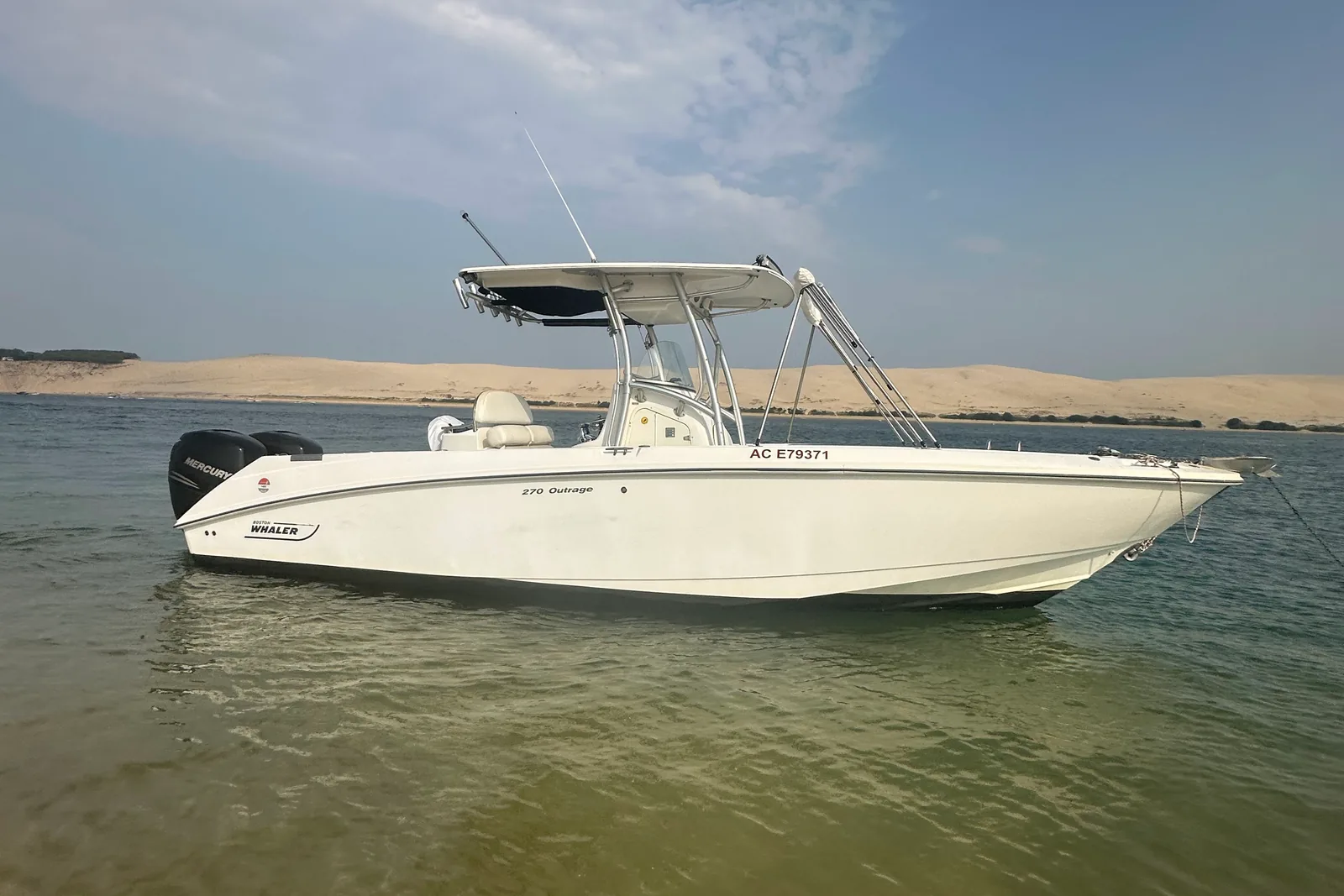 un bateau au mouillage sur le Bassin, la dune en face